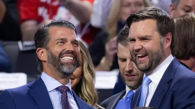 Donald Trump Jr (left) and JD Vance (right) standing next to each other and laughing