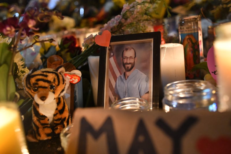 A photo of Alex Pretti is displayed at a makeshift memorial in his honor