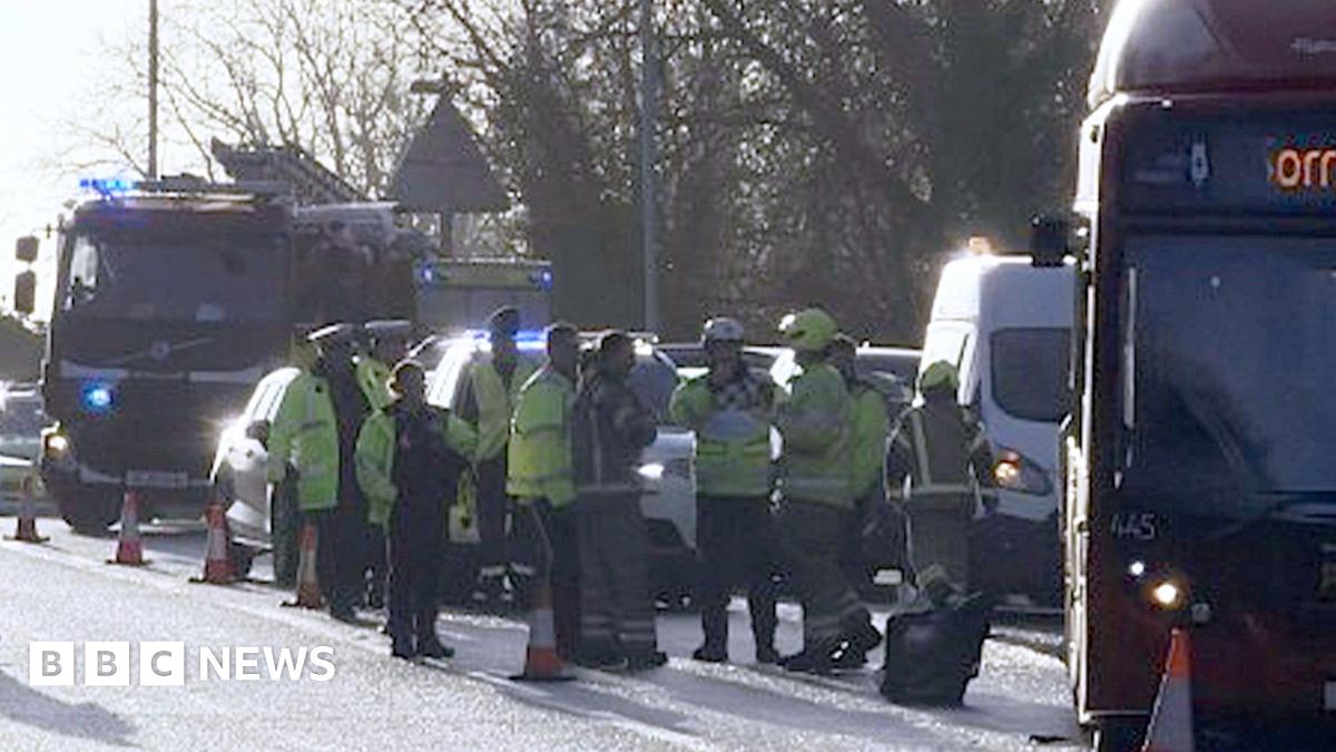 A picture of the bus and emergency services personnel, including a fire engine, on the slip road.