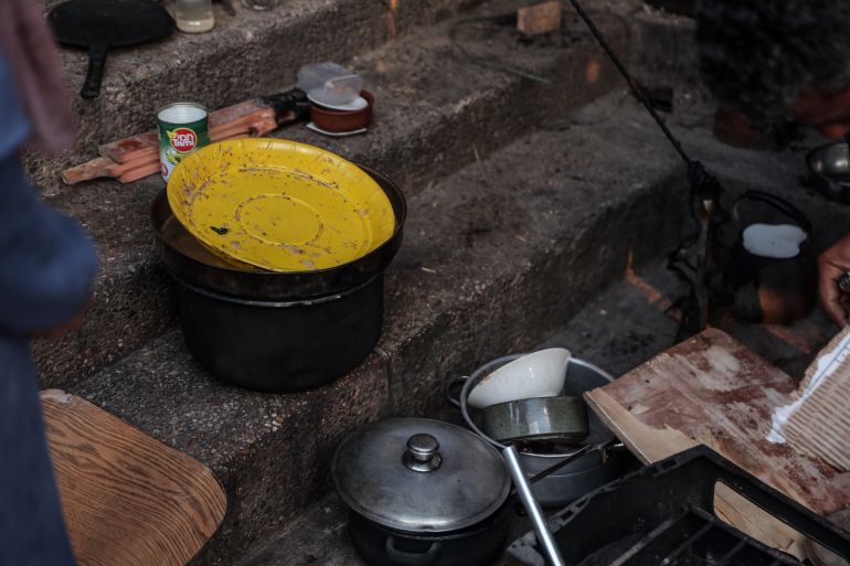 Improvised kitchen area beside the tent of Alaa’s family that includes poor, unsanitized kitchen utensils