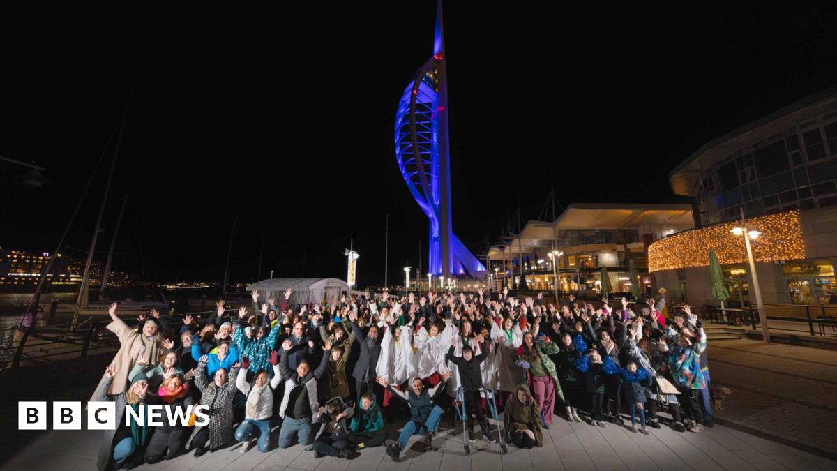 Image of a large group of people outside the Spinnaker Tower in Portsmouth