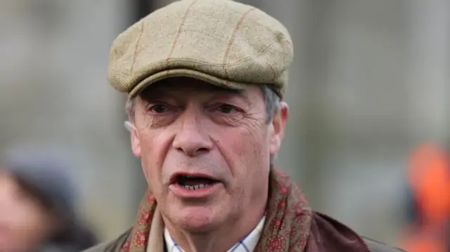 Nigel Farage wearing a flat cap