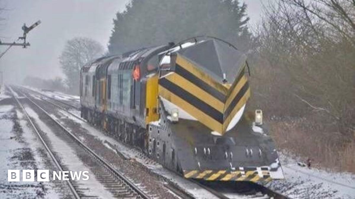 A train on a track that is covered in snow.