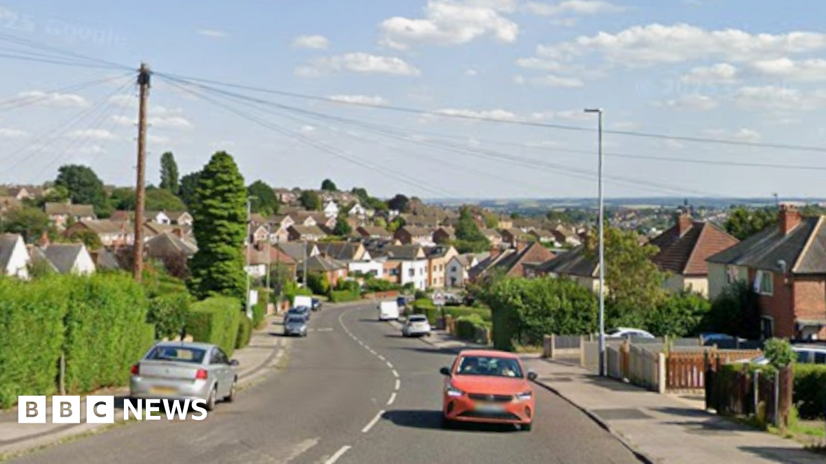 A streetview image of Cavendish Road. It is a single carriageway residential street with trees and shrubbery on either side. Cars can be seen parked along the road