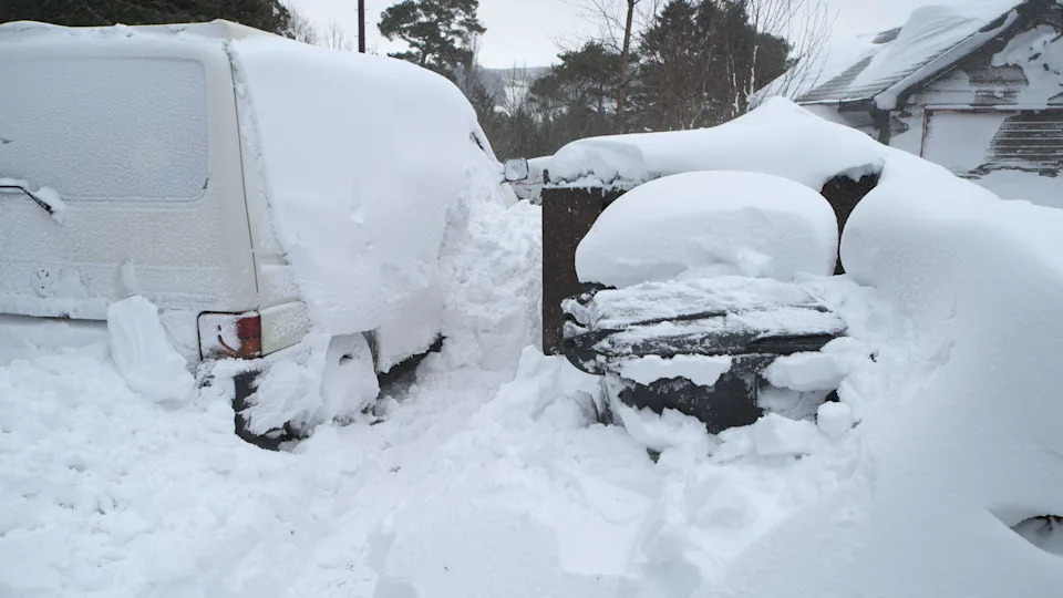 Deep snow deposited against cars in February 2018 Beast from the East storm, near Kielder Water, Northumberland, England.