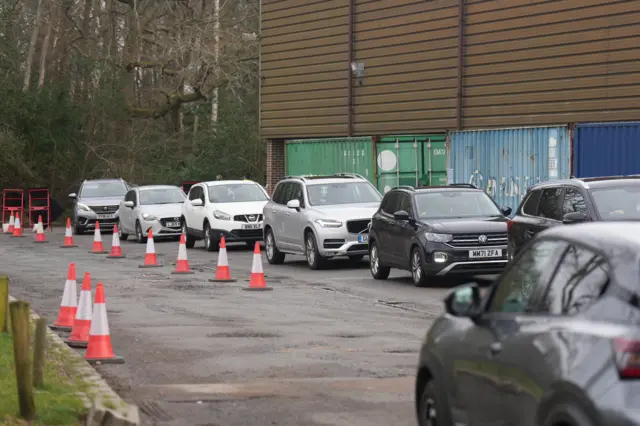 A queue of cars at the bottled water station in East Grinstead Rugby Club
