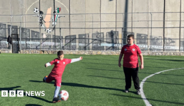 Naya is a ten year old Palestinian girl wearing a Brazil shirt on a football pitch in Bethlehem