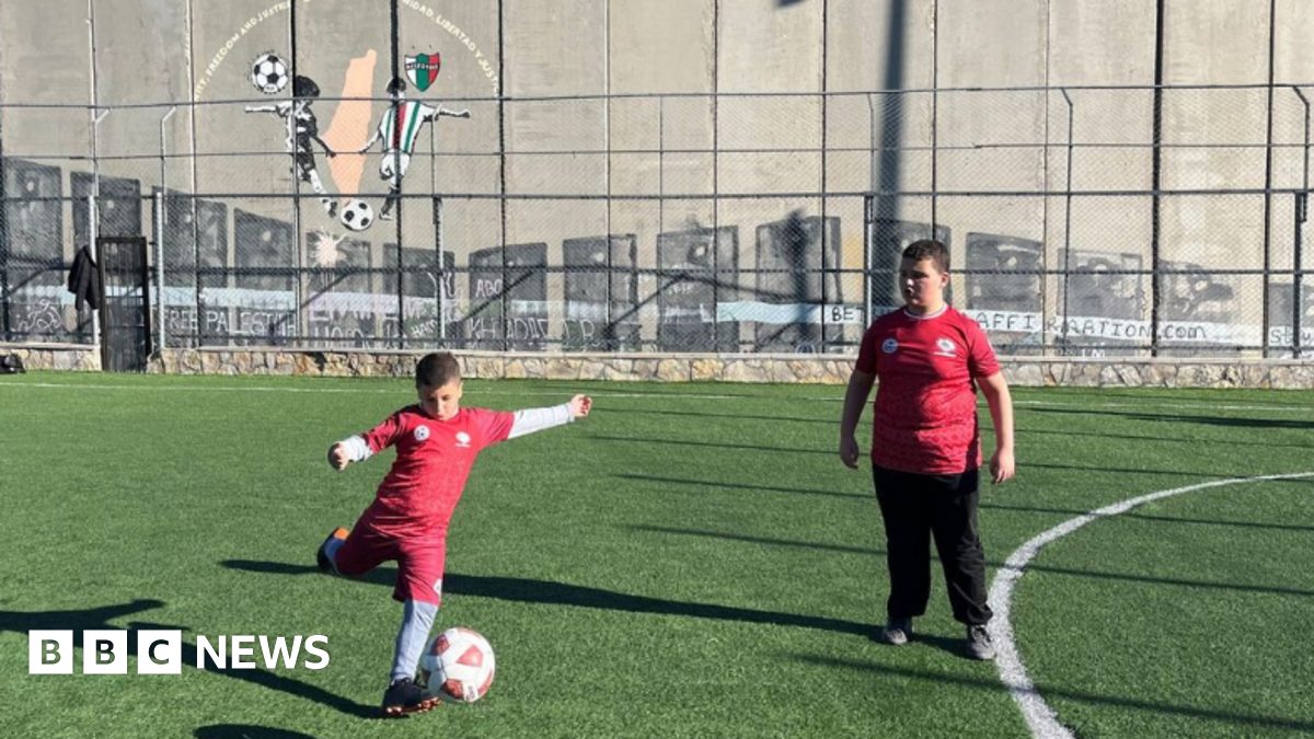 Naya is a ten year old Palestinian girl wearing a Brazil shirt on a football pitch in Bethlehem