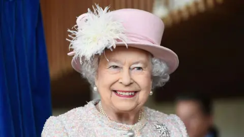Getty Images  Queen Elizabeth II is seen in a pink hat smiling during an appearance at the Chichester Theatre 