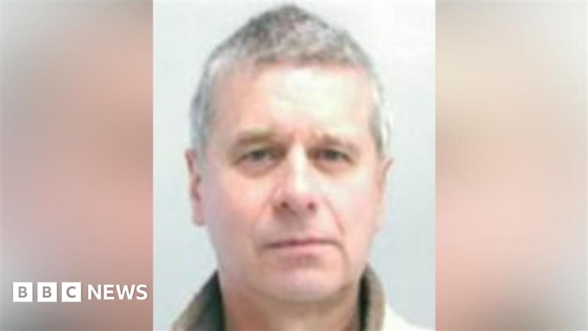 Forensic officers examine the ground by tents, explosives team vans and a police cordon on Willersley Avenue