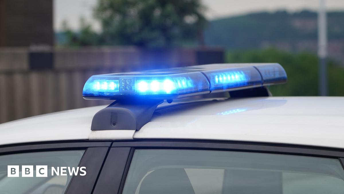A stock image of flashing blue lights on top of a police vehicle