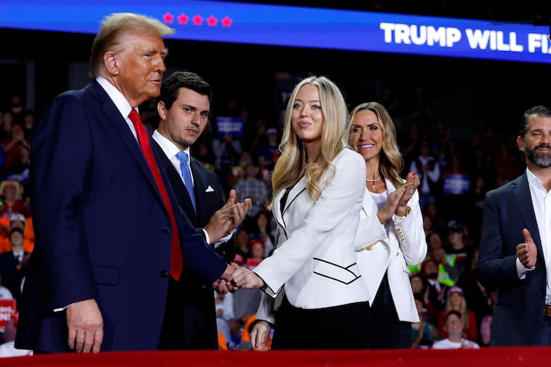 GRAND RAPIDS, MICHIGAN - NOVEMBER 05: Republican presidential nominee, former U.S. President Donald Trump, (L) shakes hands with daughter Tiffany Trump as they are joined on stage by Tiffany's husband Michael Boulos, RNC Co-chair Lara Trump and Donald Trump Jr. during Trump's final campaign rally of the election year at Van Andel Arena on November 05, 2024 in Grand Rapids, Michigan. Trump campaigned for re-election in the battleground states of North Carolina and Pennsylvania before arriving for his last rally minutes after midnight in Michigan. (Photo by Chip Somodevilla/Getty Images)