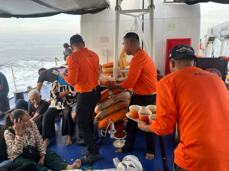 This photo released by the Philippine Coast Guard shows its personnel tending to people who were aboard the M/V Trisha Kerstin 3 around the waters of Baluk-Baluk Island, Basilan, Philippines Monday, Jan. 26, 2026. (Philippine Coast Guard via AP)