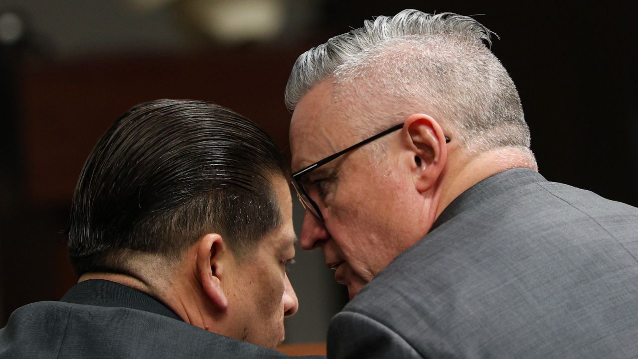 Former Uvalde school district police officer Adrian Gonzales talks with defense attorney Gary Hillier during the seventh day of Gonzales' trial at the Nueces County Courthouse in Corpus Christi, Texas, Wednesday, Jan. 14, 2026. (Sam Owens/The San Antonio Express-News via AP, Pool)