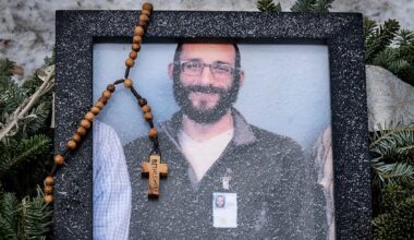 A rosary adorns a framed photo Alex Jeffrey Pretti, a 37-year-old intensive-care unit nurse who was gunned down by Border Patrol agents in Minneapolis on Jan. 25, 2026. (ROBERTO SCHMIDT / AFP via Getty Images)