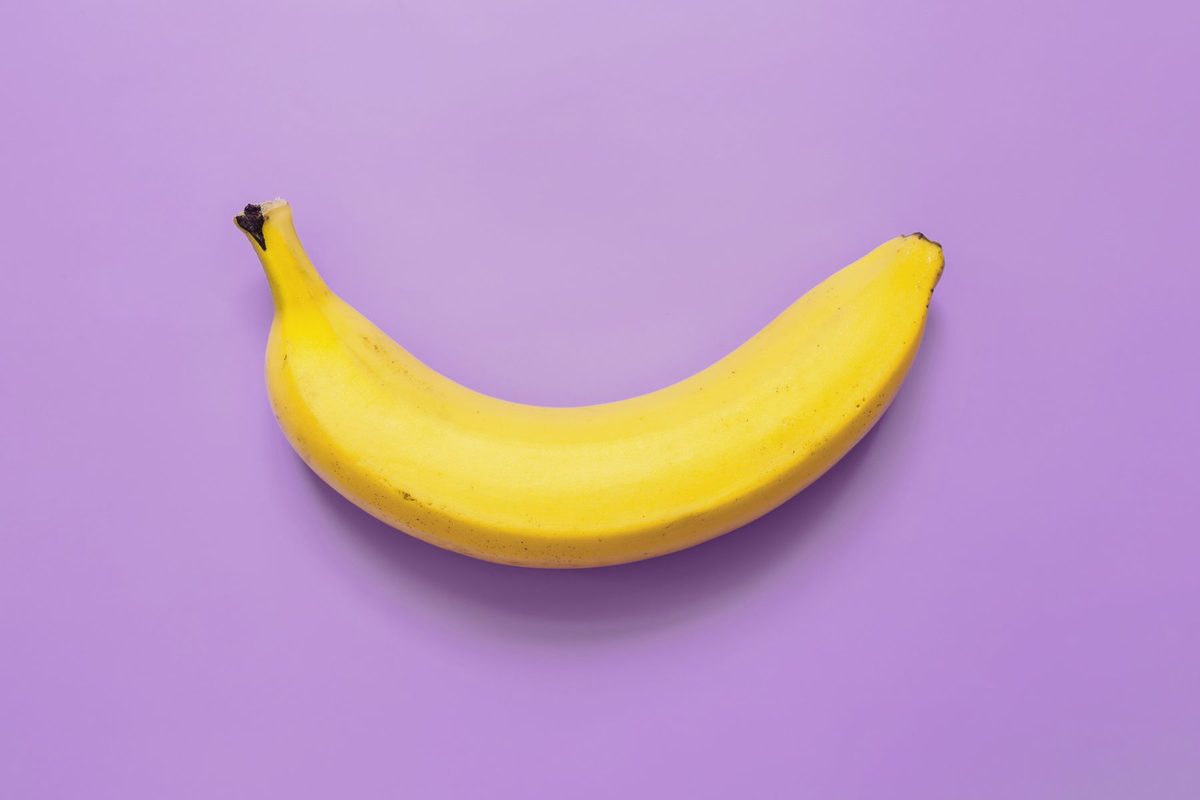 A banana on a purple background