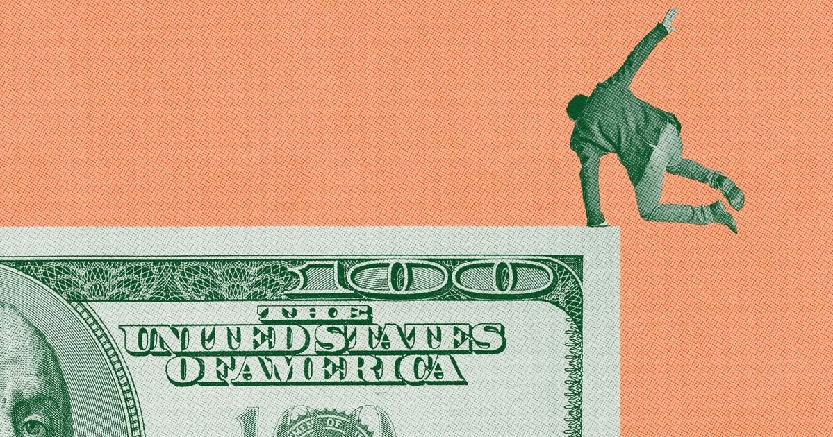 A modern two-story house with large windows, wood paneling, and a paved driveway, surrounded by lush green trees and manicured garden beds.