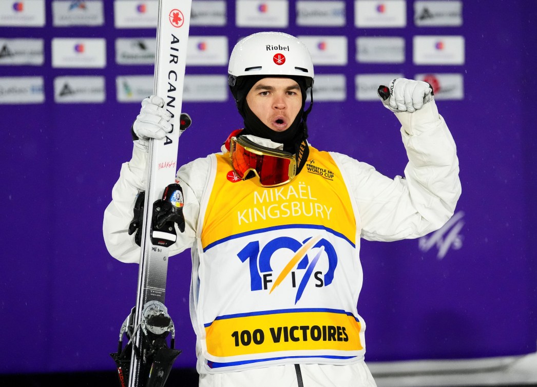 Mikael Kingsbury wears a yellow bib that says 100 victories