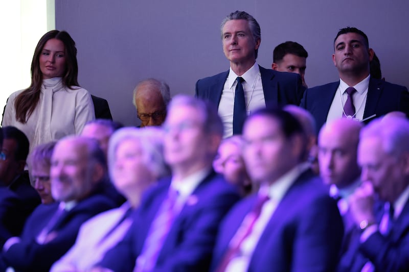 California Governor Gavin Newsom (C) listens to U.S. President Donald Trump address the World Economic Forum in the Davos Congress Center on January 21 in Davos, Switzerland.