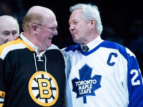 Former Toronto Maple Leafs captain Darryl Sittler, right, shares a joke with former Boston Bruins goaltender Dave Reece. The two took part in a pre-game ceremony to celebrate Sittler's ten-point game ahead of Leafs' playing the New Jersey Devils on Thursday, Feb. 4, 2016.
