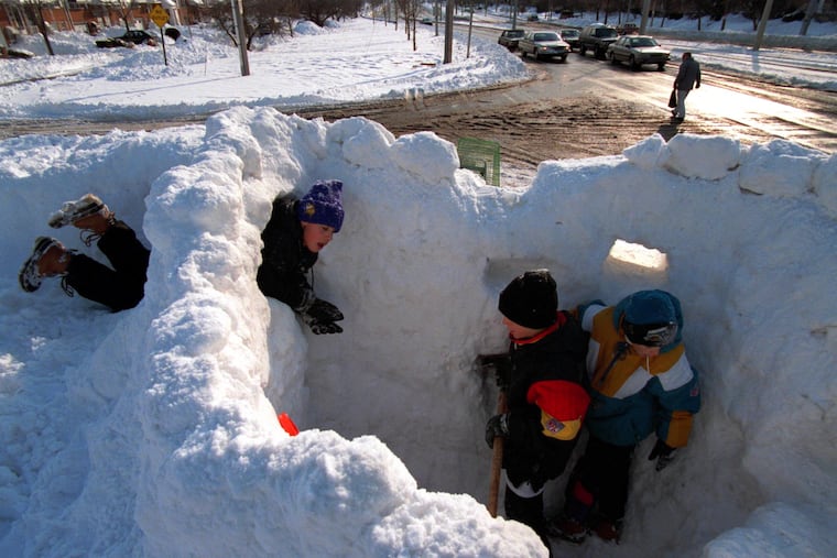 Kids enjoy their third day off from school by building a snow fort on the corner of Island and Tanager in Southwest Philly on Jan. 10, 1996.