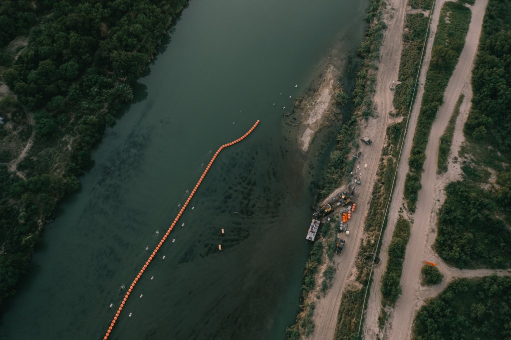 A string of buoys is deployed to prevent migrants from swimming across the Rio Grande in Eagle Pass on July 13, 2023.