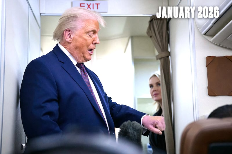 President Donald Trump holds up his hand after being asked about it by a reporter while speaking to journalists while in flight on Air Force One, traveling from Shannon, Ireland en route Joint Base Andrews in Maryland on Jan. 22, 2026. Trump is returning from Davos, Switzerland after attending the World Economic Forum.