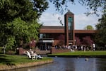 People gather outside the Mark O. Hatfield Library on the campus of Willamette University in Salem, Ore., Saturday, April 27, 2019. Lower enrollment in recent years has led to other cuts.