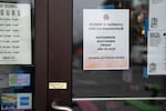 A sign hangs in the door of Mis Tacones restaurant in Portland, Ore. on Thursday, Jan. 29, 2026.