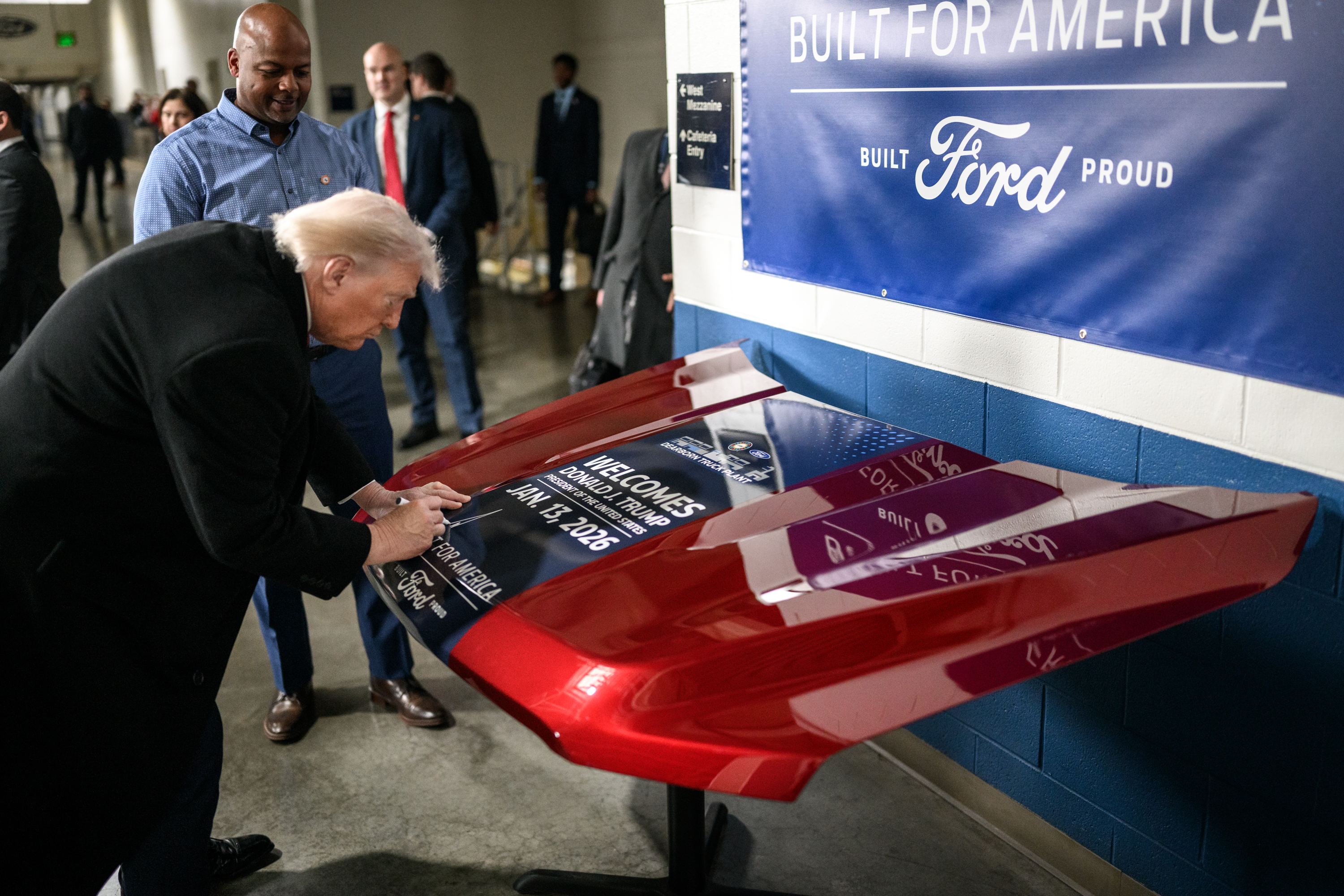 President Donald Trump signs a vehicle hood and greets plant workers at the Ford River Rouge Complex in Dearborn, Michigan on Tuesday, January 13, 2026. (Official White House Photo by Daniel Torok)