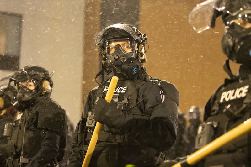 Protesters clash with law enforcement while holding a 'noise demonstration' outside of a hotel believed to be housing federal immigration agents near Minneapolis, United States, on January 26, 2025.