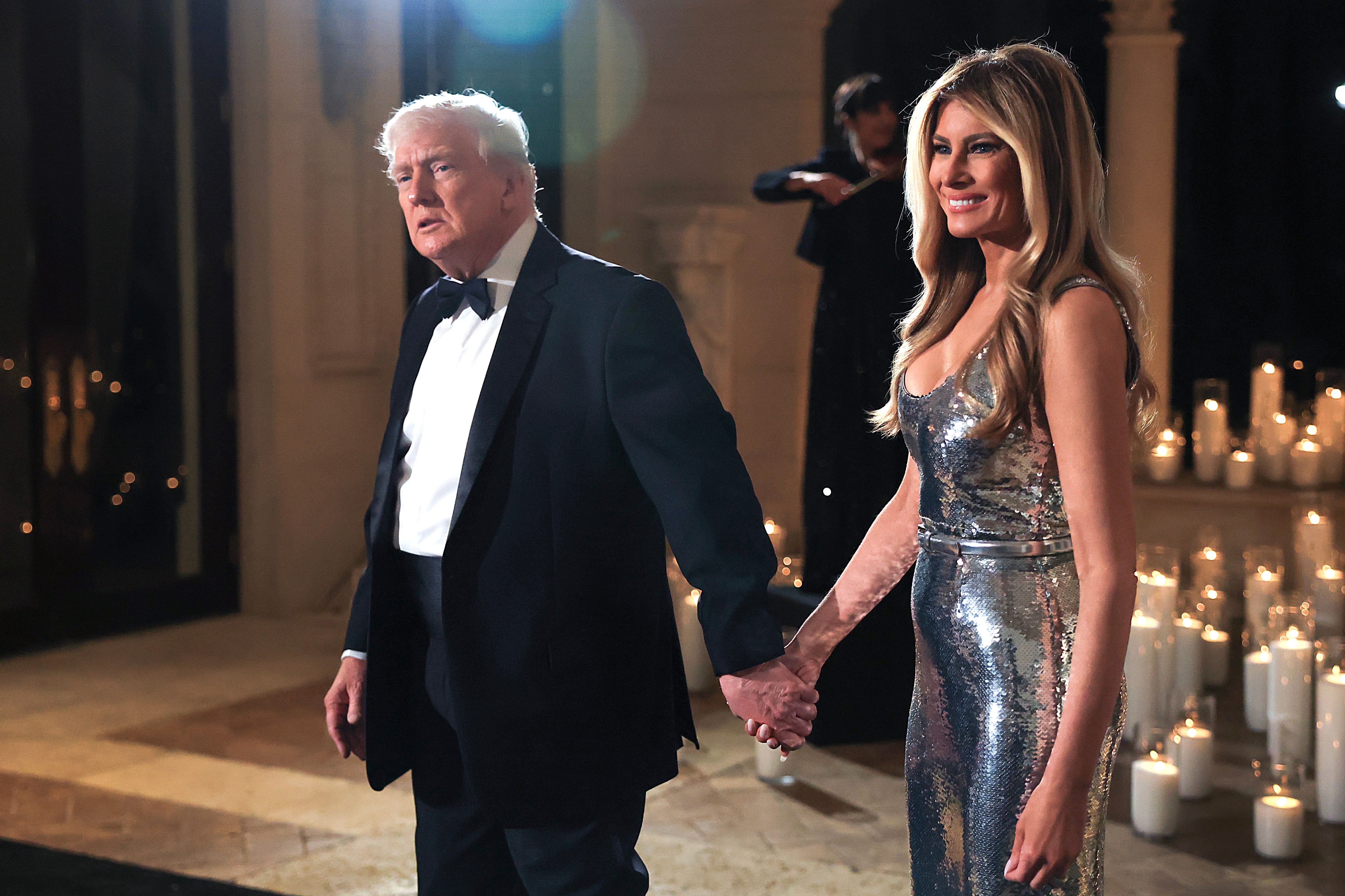 President Donald Trump stands with First Lady Melania Trump at a New Year’s Eve event