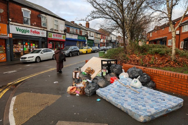 Fly tipped rubbish dumped on Caldmore Rd in run down area of Caldmore suburb of Walsall, West Midlands.