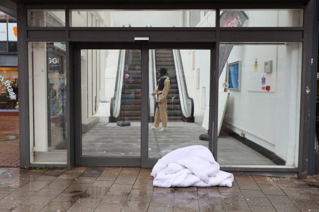 Sleeping bag and blankets outside a shop in Walsall town centre, West Midlands. Walsall the worst place in Britain for quality of life in 2025 according to 2025 good Growth for Cities Index. // Residents of Britain's worst town for quality of life says its like living in "real-life episode of Shameless" where beggars earn more money than them by sitting outside a Wetherspoons. The Black Country town of Walsall, West Mids, was ranked the most deprived town in the UK in the 2025 Good Growth for Cities Index. It was once the centre of the UK's leather trade, with scores of shopping chains and independent shops, but has now descended into a "war-zone." Locals say they are too scared to walk the streets, which have become no-go zones after dark, due to "feral" youths, gang violence and drug addicts. Grim photos taken this week show how the town has descended into a "slum" - from dumped rubbish, boarded up houses and a surging homeless population. Photo released 19/01/2026