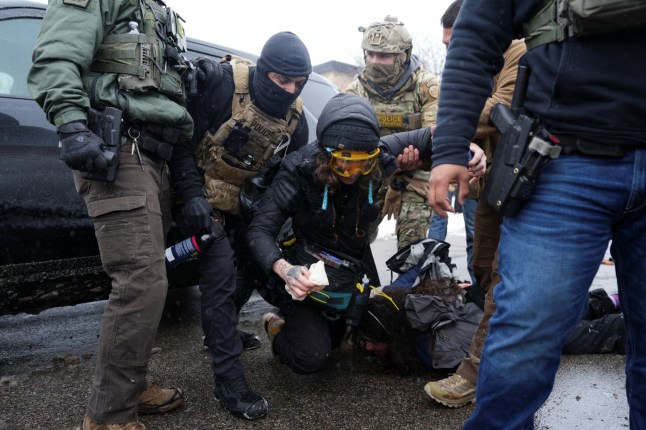 A person who was offering medical aid to a detained person is held by federal agents as immigration enforcement continues after a U.S. Immigration and Customs Enforcement (ICE) agent fatally shot Renee Nicole Good on January 7 during an immigration raid, in Minneapolis, Minnesota, U.S., January 21, 2026. REUTERS/Leah Millis