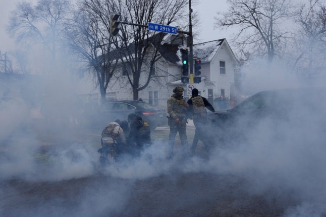 Federal agents detain a person while they're surrounded by tear gas used to deter protesters, as immigration enforcement continues after a U.S. Immigration and Customs Enforcement (ICE) agent fatally shot Renee Nicole Good on January 7 during an immigration raid, in Minneapolis, Minnesota, U.S., January 21, 2026. REUTERS/Leah Millis