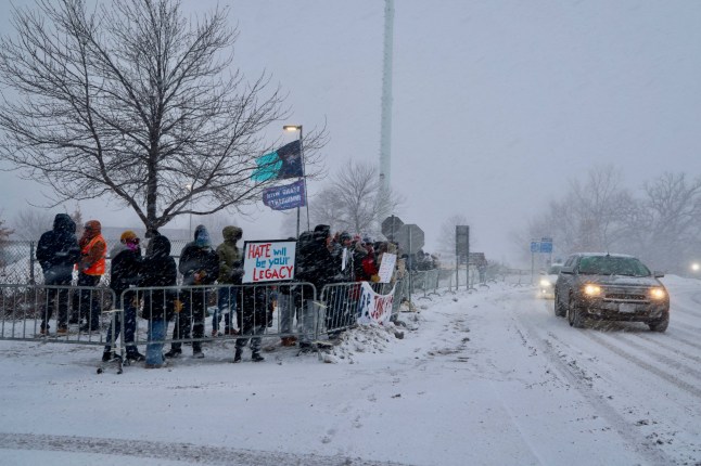 January 21, 2026, Minneapolis, Mn, USA: ICEHOLES OUT! NOT AFRAID!?? A man???s sign reads as he braves frigid temperatures in front of the entrance of the ICE detention facility at the Whipple Federal Building in Minneapolis. 21 Jan 2026 Pictured: January 21, 2026, Minneapolis, Mn, USA: A snow storm, frigid temperatures and aggressive ICE agents could not intimate the Minnesota protestors who continue to gather in loud protest in front of the entrance of the ICE detention facility at the Whipple Federal Building in Minneapolis to decry what they describe as the brutality and unconstitutionality of federal agents and abductions of their community members. Photo credit: ZUMAPRESS.com / MEGA TheMegaAgency.com sales@mega.global