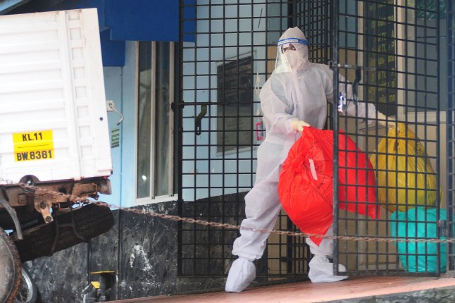 TOPSHOT - A health worker wearing protective gear disposes biohazard waste from a Nipah virus isolation center at a goverment hospital in Kozikode, in India's southern state of Kerala on September 16, 2023. India has curbed public gatherings and shut some schools in the southern state of Kerala after two people died of Nipah, a virus from bats or pigs that causes deadly fever, officials said on September 14. (Photo by AFP) (Photo by -/AFP via Getty Images)