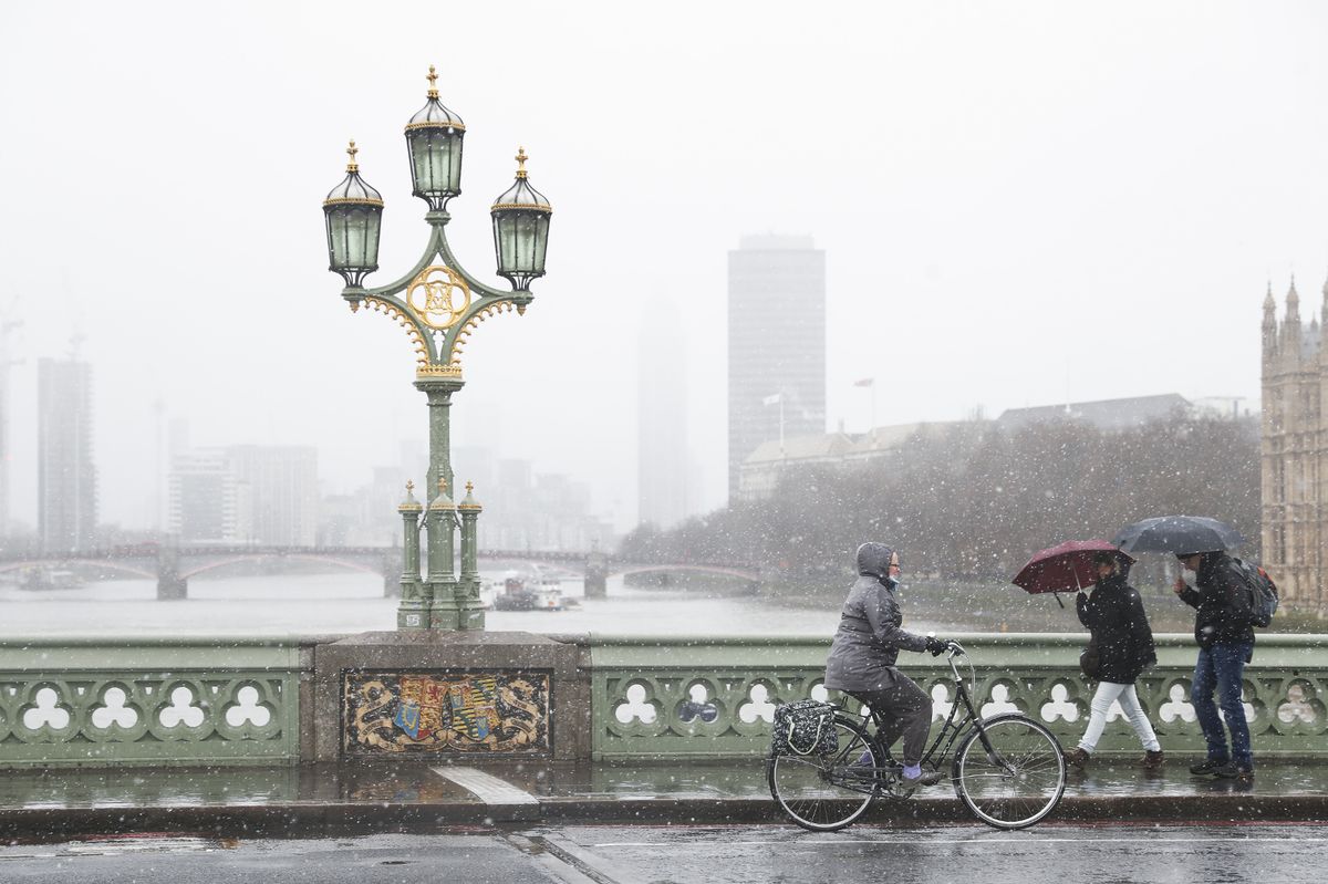 Snow falls at London Bridge as the capital is hit by bad weather