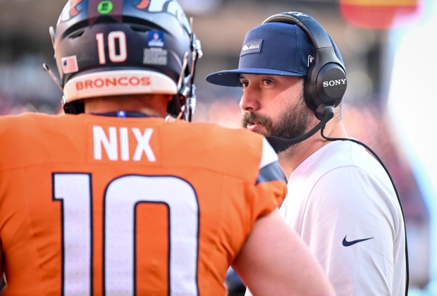 Quarterbacks coach Davis Webb of the Denver Broncos speaks to Bo Nix (10)  during the first quarter against the Jacksonville Jaguars at Empower Field at Mile High in Denver, Colorado on Sunday, Dec. 21, 2025. (Photo by AAron Ontiveroz/The Denver Post)