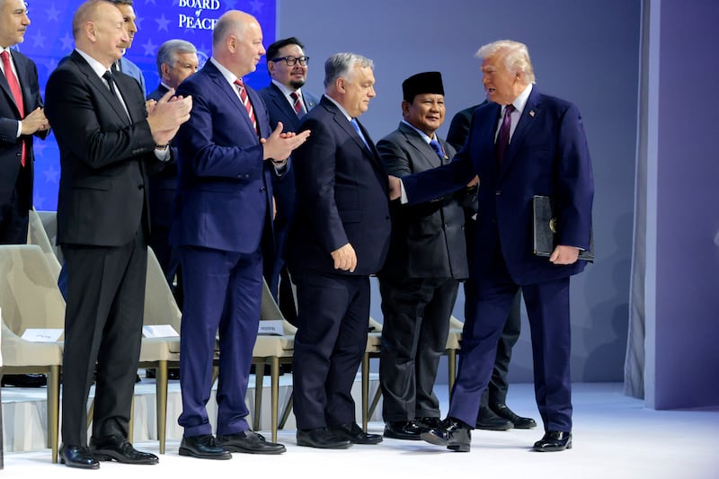 President Donald Trump greets Prime minister of Hungary Viktor Orbán as he presents the “Board of Peace” onstage at the World Economic Forum (WEF) on January 22, 2026 in Davos, Switzerland.