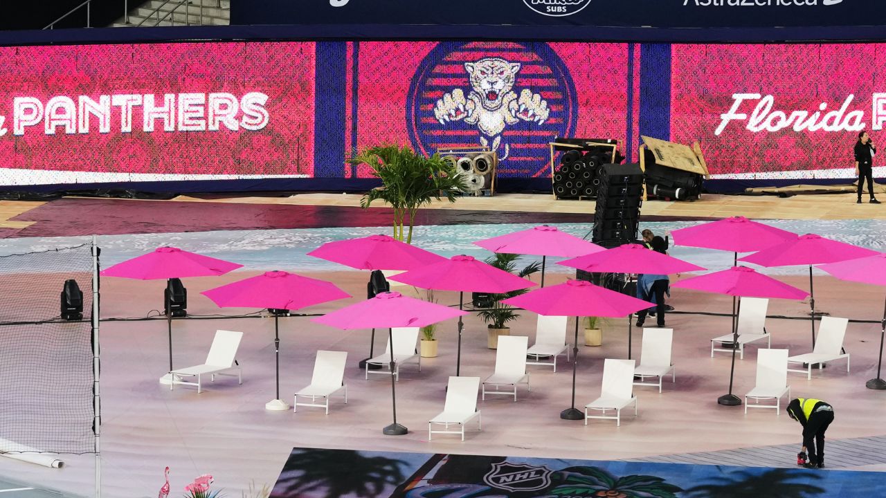 Lounge chairs and umbrellas are shown alongside the ice for the upcoming NHL Winter Classic between the Florida Panthers and New York Rangers, Tuesday, Dec. 30, 2025, at loanDepot Park in Miami. (AP Photo/Lynne Sladky)