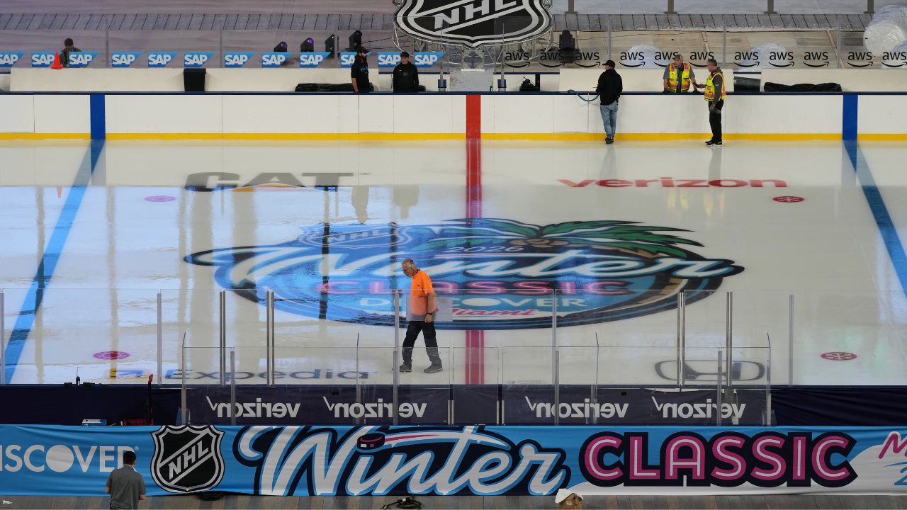 Workers prepare the ice for the upcoming NHL Winter Classic between the Florida Panthers and New York Rangers, Tuesday, Dec. 30, 2025, at loanDepot Park in Miami. (AP Photo/Lynne Sladky)