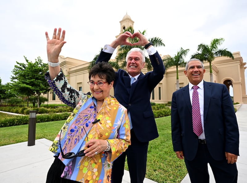 Elder and Sister Uchtdorf gesture outside the McAllen Texas Temple.
