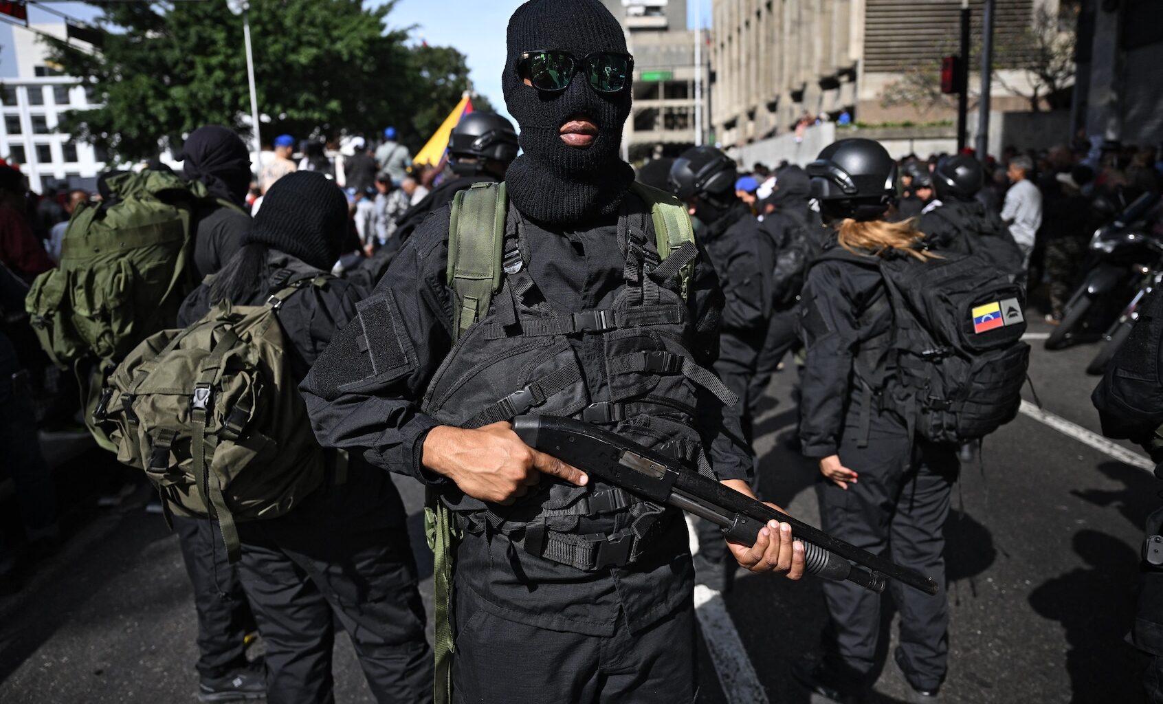 Armed supporters of Venezuela's President Nicolás Maduro gather near the Miraflores presidential palace in Caracas, Jan. 3, 2026. (Federico Parra / AFP via Getty Images)