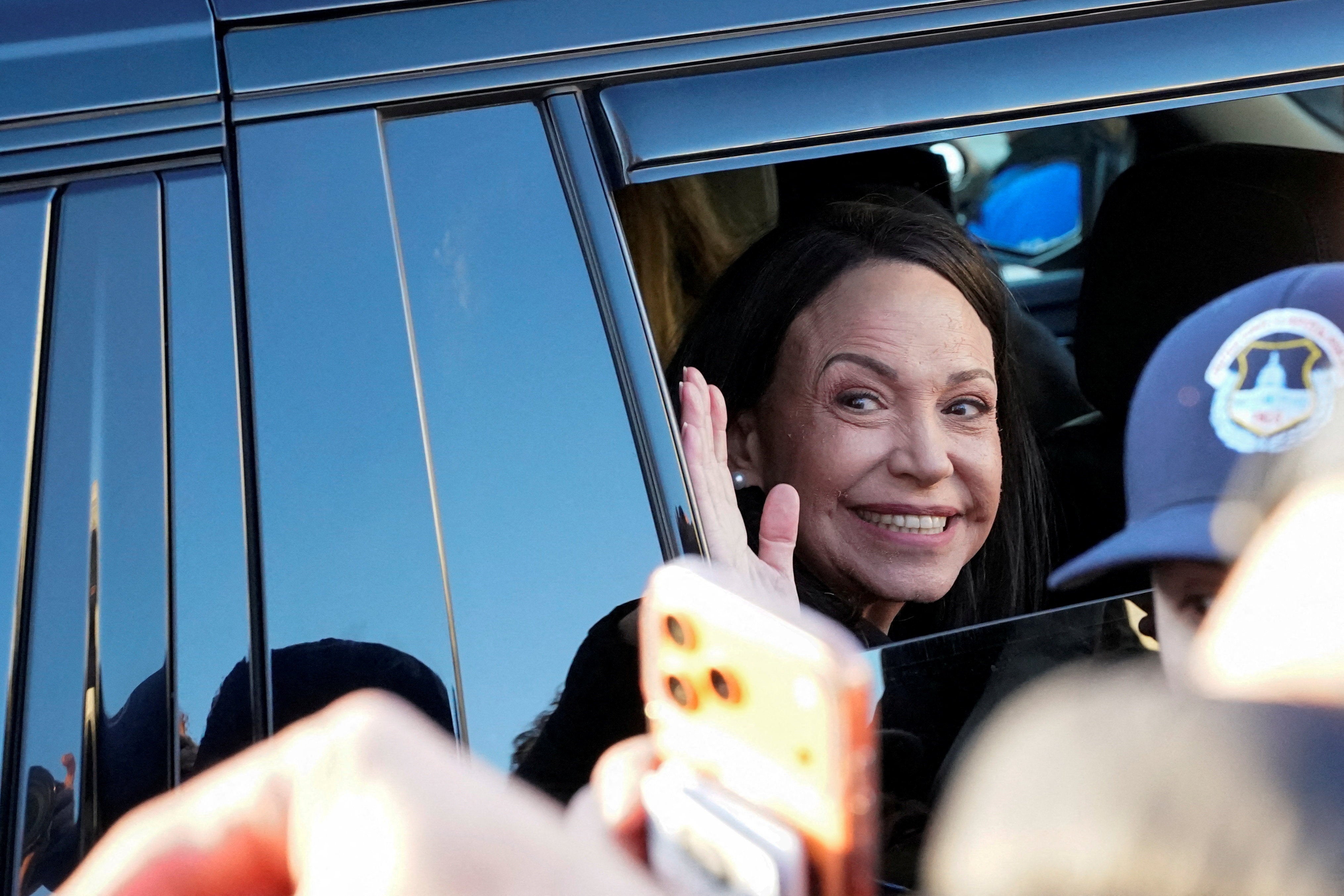 Venezuelan opposition leader Maria Corina Machado waves from a vehicle as she leaves the U.S. Capitol after a meeting with U.S. senators, following an earlier meeting with U.S. President Donald Trump at the White House