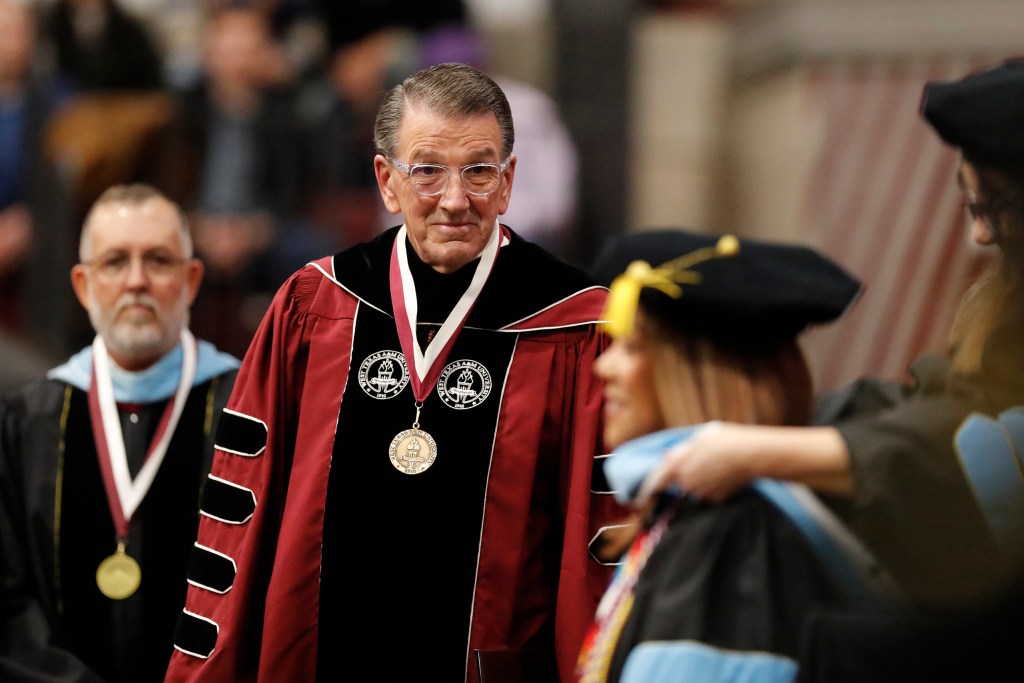 University President Walter V. Wendler prepares to help with the hooding of a graduating student during the West Texas A&M University Commencement program at the WTAMU campus in Canyon on Saturday, Dec. 9, 2023.