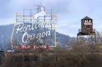 Portland’s iconic landmarks, the White Stag sign and Old Town water tower, in downtown Portland, March 26, 2024.