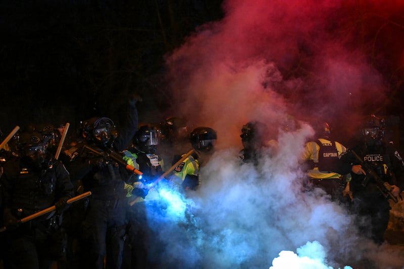 MINNEAPOLIS, MN - JANUARY 14 U.S. Law enforcement officers clash with protesters at the scene where a man was allegedly shot in the leg during a federal immigration enforcement operation in north Minneapolis on January 14, 2026 in Minneapolis, Minnesota. Federal agents are conducting a thirty day immigration operation in Minnesota. Last week Renée Good was fatally wounded by an Immigration and Customs Enforcement officer. (Photo by Joshua Lott/The Washington Post via Getty Images)