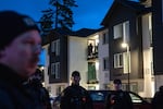 Investigators enter the apartment complex where police found the two injured people involved in the shooting at Northeast 146th Avenue and East Burnside on Thursday, Jan. 8, 2026 in Portland, Ore. According to police, following the shooting on Main Street, officials found the two injured people at an apartment complex several blocks away.